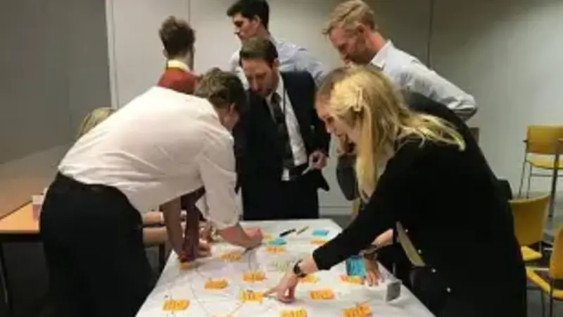 People using sticky notes to develop ideas around policy.