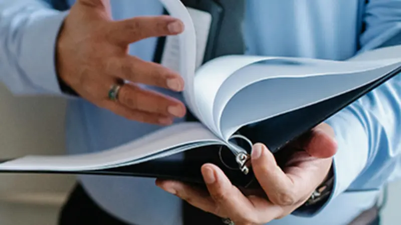 person looking at reports or contracts